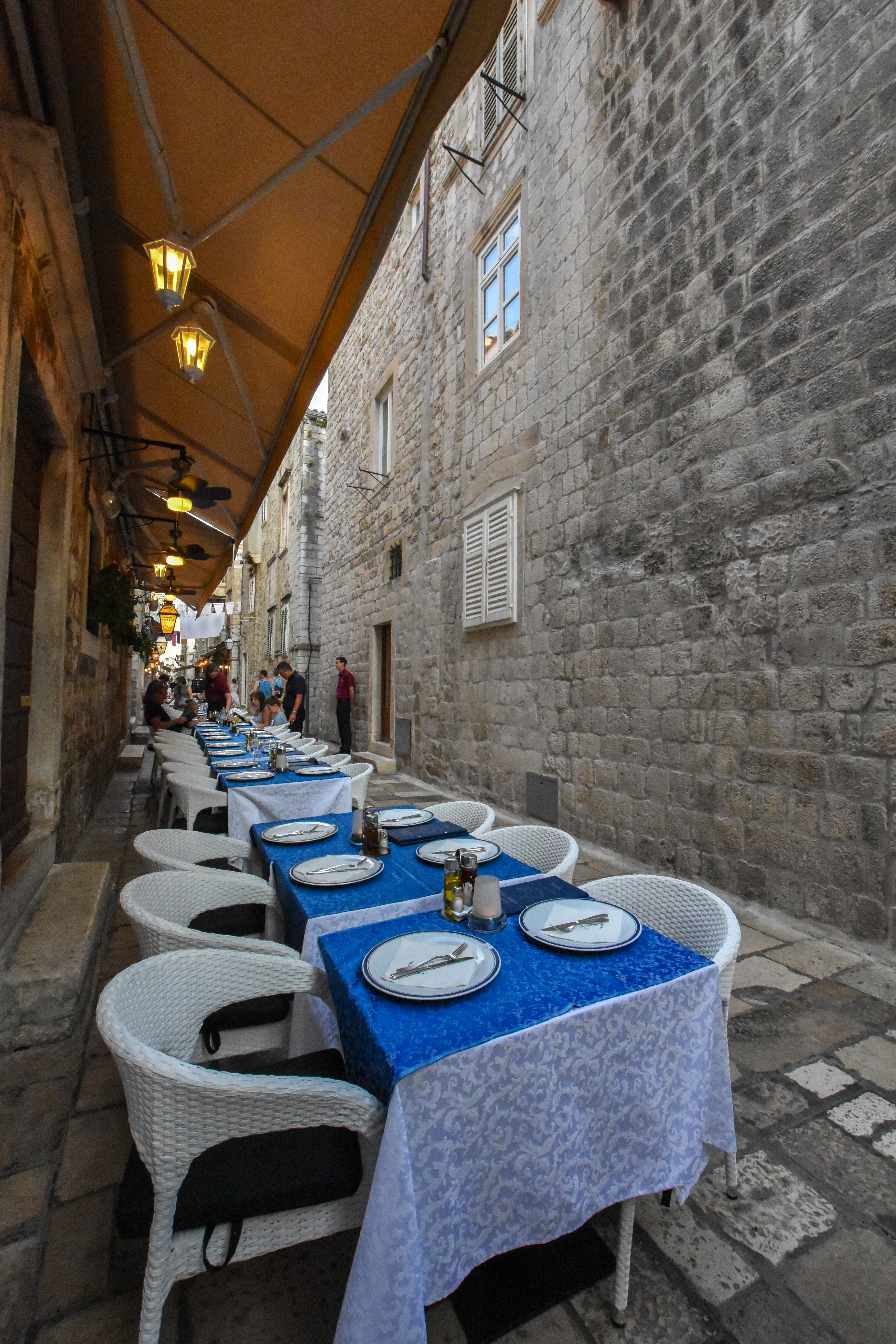 restaurant and interior design photography of dubrovnik's michelin star restaurant exterior outdoor decoration tables on a sunny day on the historic and famous streets of croatia as a dining place in travel destination croatia